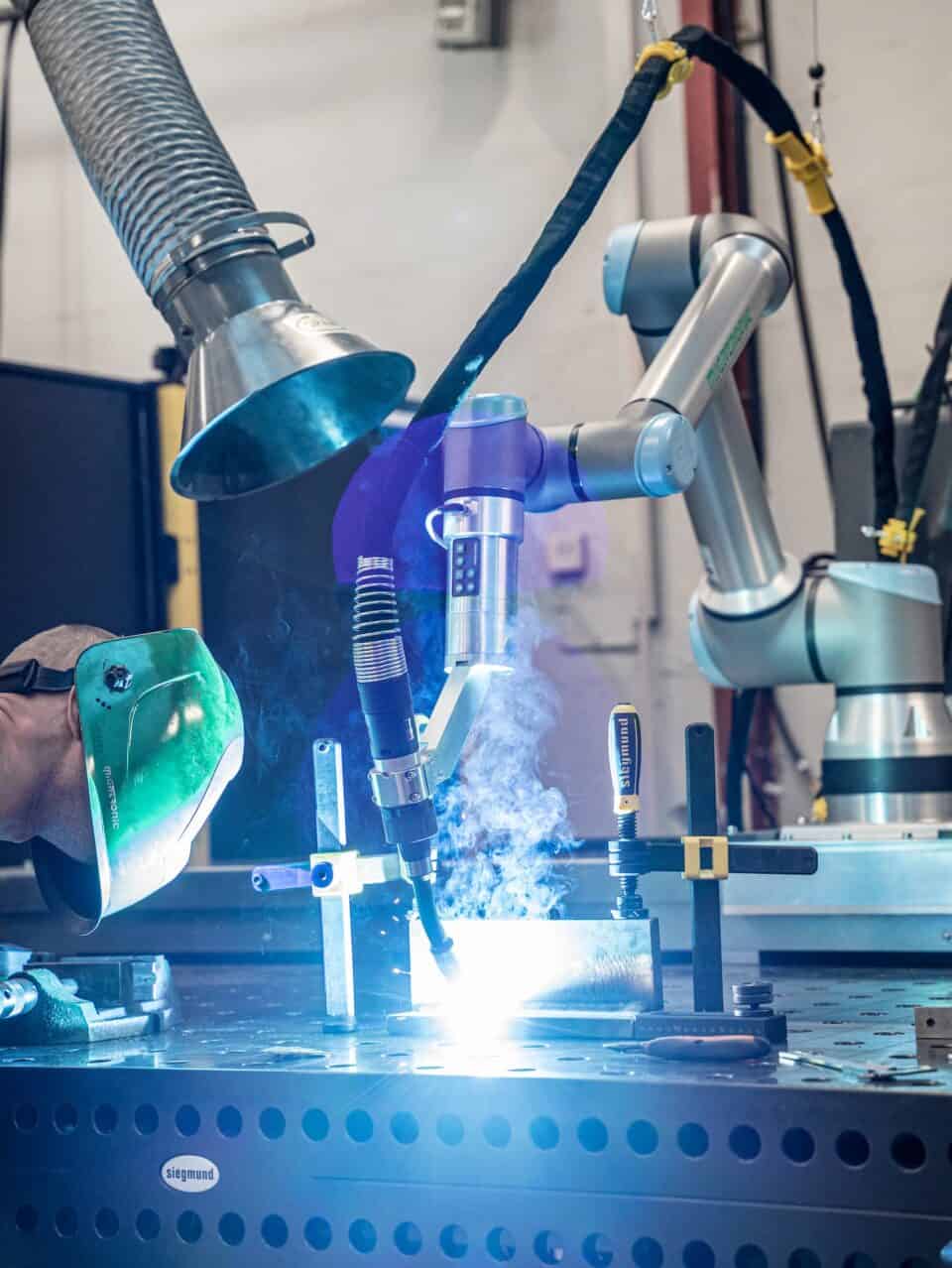 CoWelder in action, mig welding with operator surveying